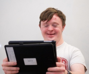 Learner holding tablet